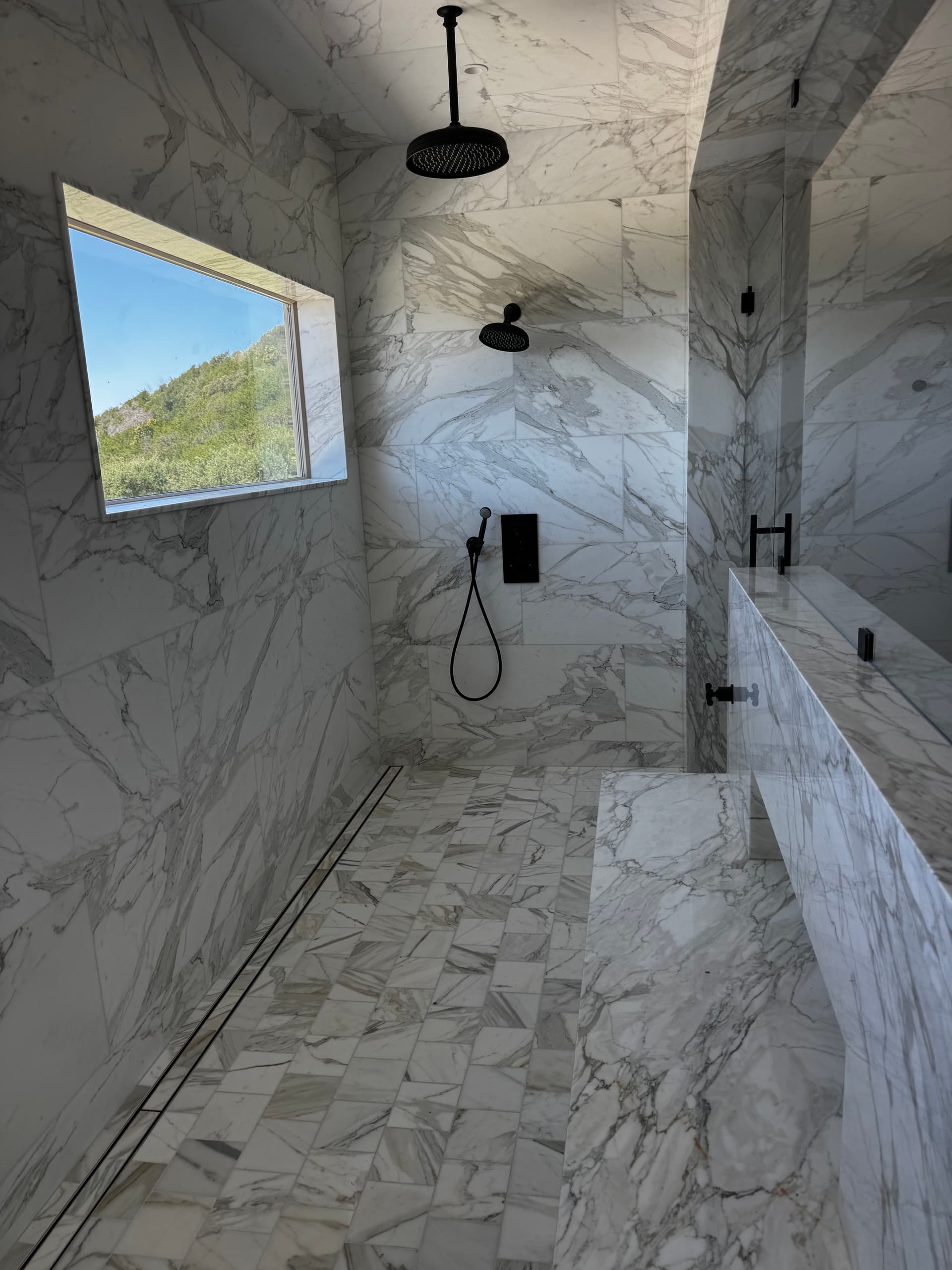 His-and-Hers Marble Shower Build with a View image