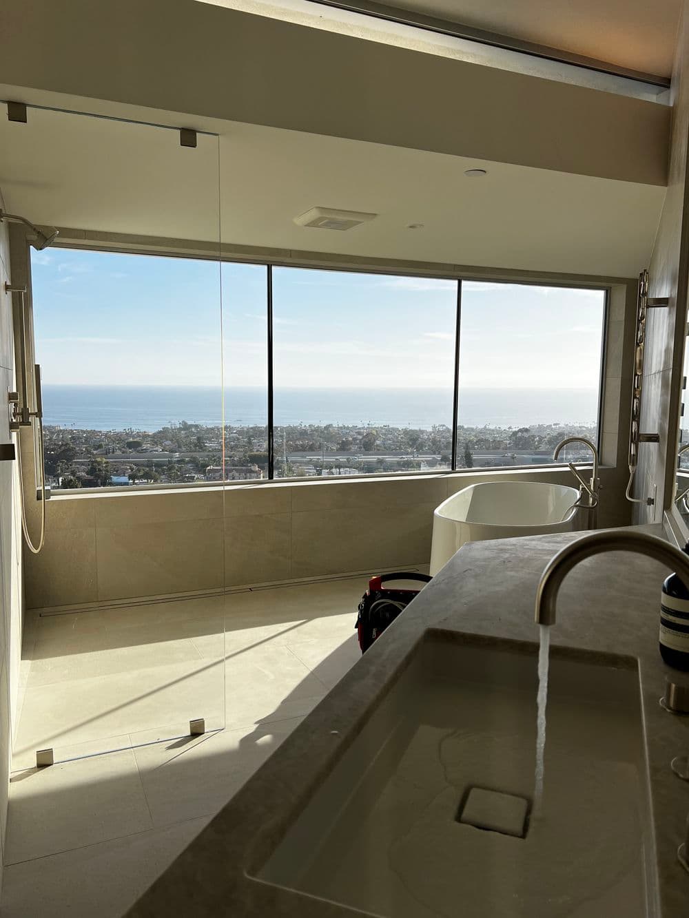 Luxury bathroom with panoramic ocean views, modern fixtures, and elegant design.
